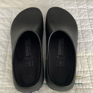 Lady’s new black polyurethane clogs. Never worn.